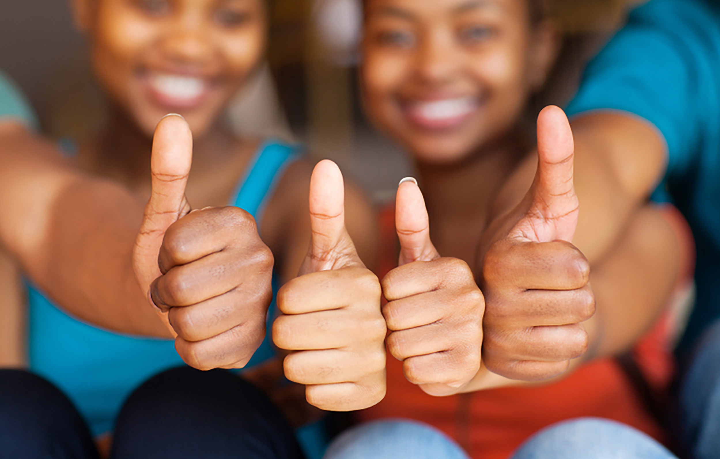 group of african friends thumbs up closeup